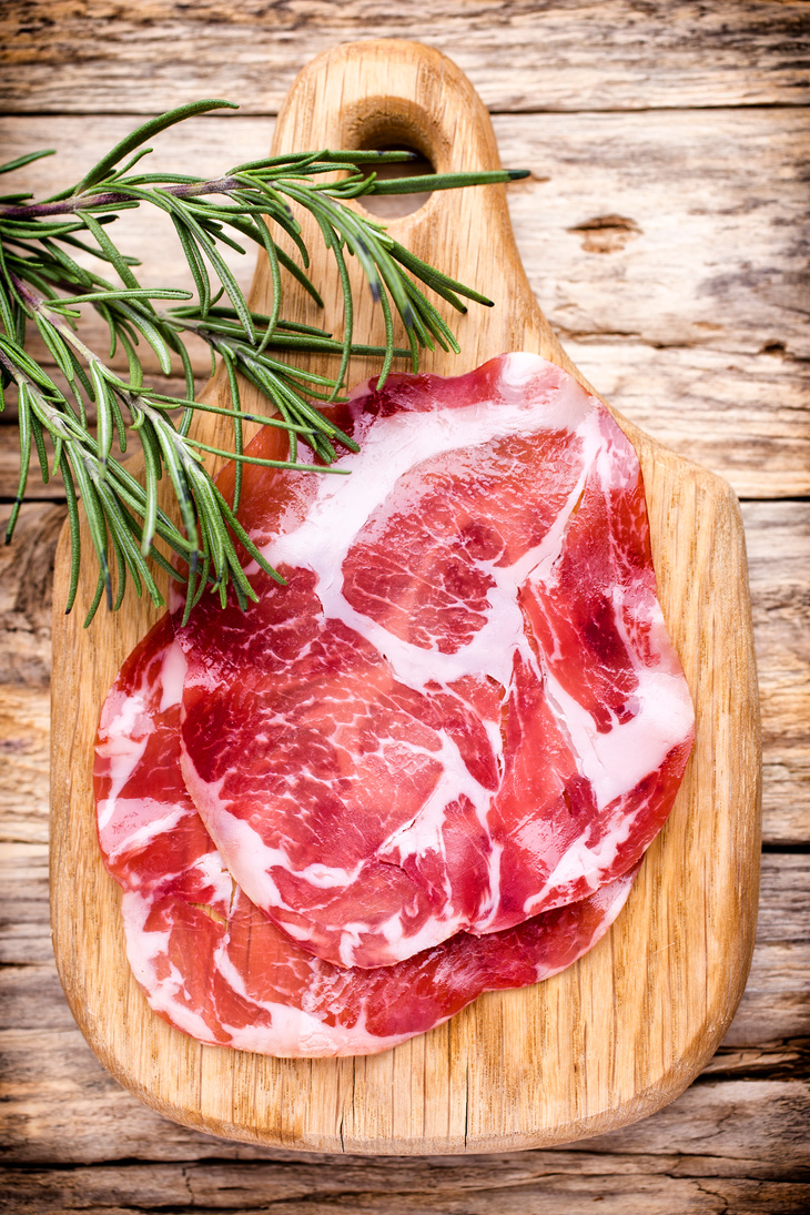 Dried pig meat slices. Delicatess.